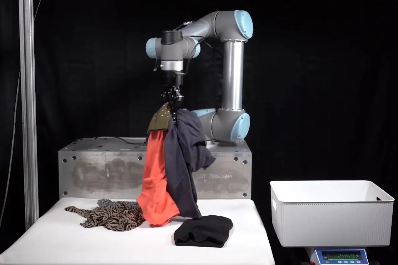 Image showing robot arm with objects to be tidied away.